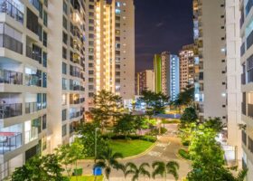 High-rise residential towers in Tampines District 18 at night, illustrating the private condominium and executive condominium landscape compared in the Pinery Residences vs Rivelle Tampines analysis.