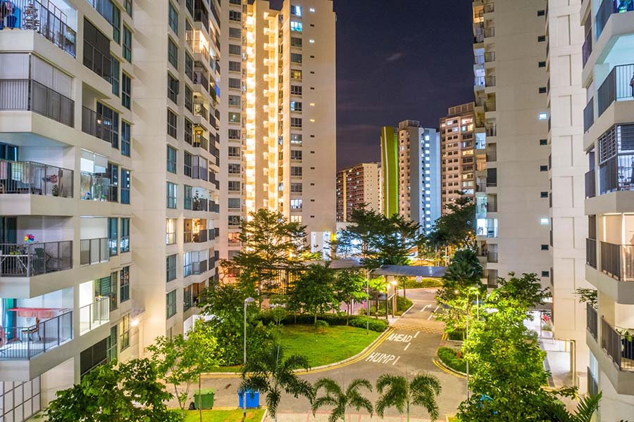 High-rise residential towers in Tampines District 18 at night, illustrating the private condominium and executive condominium landscape compared in the Pinery Residences vs Rivelle Tampines analysis.