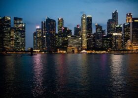 Singapore residential skyline showing high-rise condominium towers against the evening cityscape.