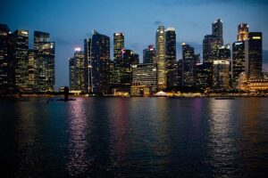 Singapore residential skyline showing high-rise condominium towers against the evening cityscape.